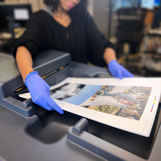 Print operator holding sustainable photo prints.